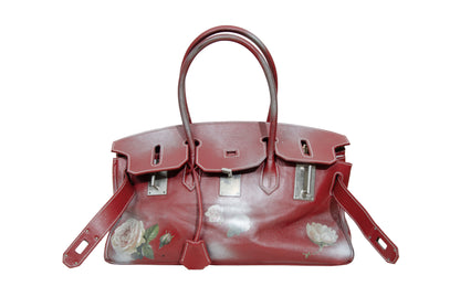 Vintage Italian red leather east west handbag with turn lock closure and floral motif
