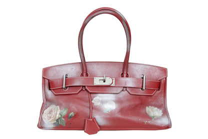 Vintage Italian red leather east west handbag with turn lock closure and floral motif