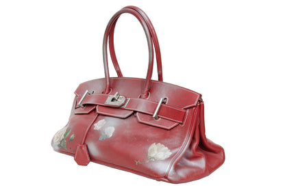 Vintage Italian red leather east west handbag with turn lock closure and floral motif